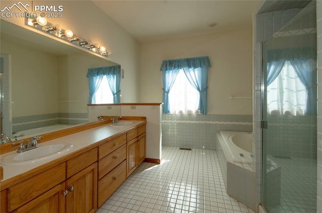 3012 S Electra Dr, Colorado Springs, CO 80906 - full bath with tile patterned flooring, a bath, a shower stall, tile walls, and wainscoting