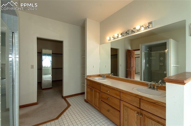 3012 S Electra Dr, Colorado Springs, CO 80906 - bathroom featuring double vanity, a shower stall, and tile patterned floors