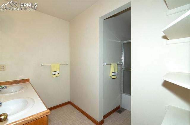 3012 S Electra Dr, Colorado Springs, CO 80906 - full bath with double vanity, enclosed tub / shower combo, and tile patterned floors