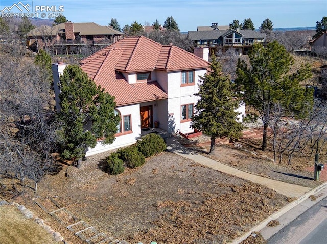 3012 S Electra Dr, Colorado Springs, CO 80906 - mediterranean / spanish-style home with a tiled roof, stucco siding, and a residential view