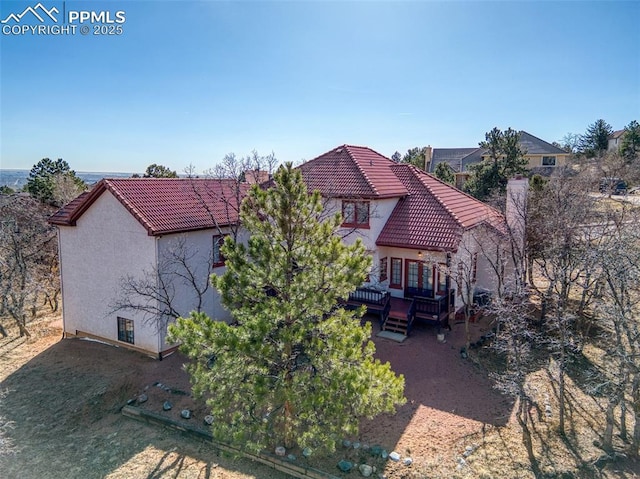 3012 S Electra Dr, Colorado Springs, CO 80906 - back of house with a tiled roof, stucco siding, and a deck