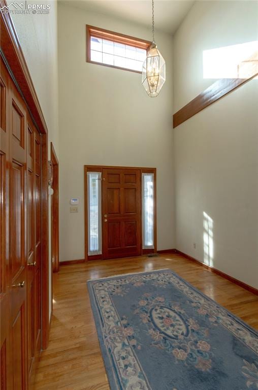 3012 S Electra Dr, Colorado Springs, CO 80906 - foyer entrance with a high ceiling and light wood-style flooring