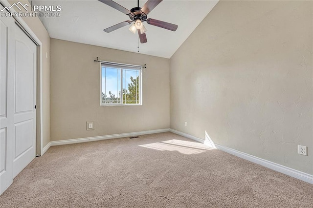 unfurnished bedroom with carpet flooring, ceiling fan, baseboards, and vaulted ceiling