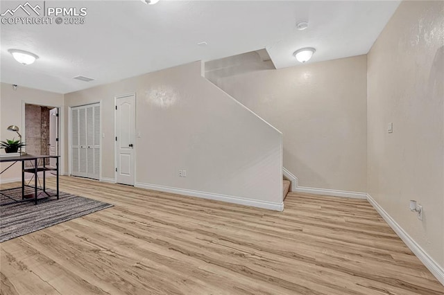 interior space featuring visible vents, stairway, wood finished floors, and baseboards