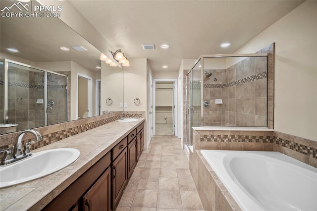 full bathroom featuring a shower stall, visible vents, and a sink