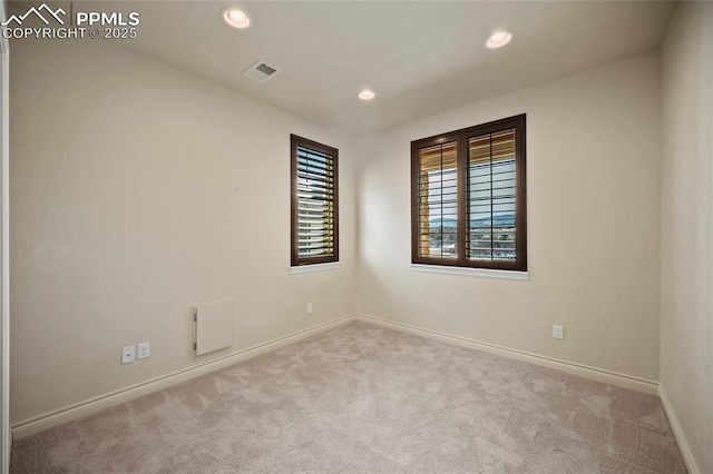 empty room featuring recessed lighting, visible vents, baseboards, and carpet flooring