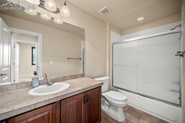 bathroom featuring vanity, visible vents, enclosed tub / shower combo, tile patterned flooring, and toilet