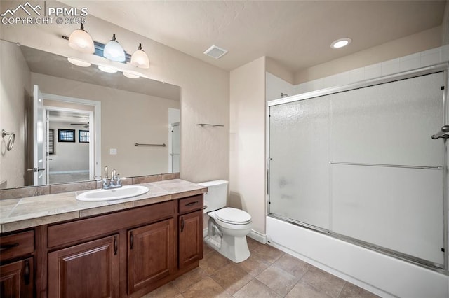 full bathroom featuring visible vents, tile patterned floors, toilet, enclosed tub / shower combo, and vanity