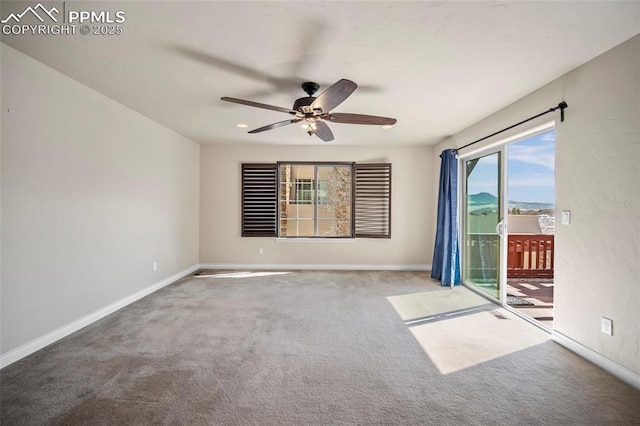 spare room featuring baseboards, a ceiling fan, and carpet flooring