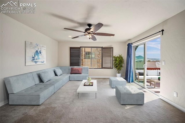 carpeted living room with baseboards and ceiling fan