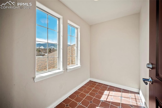 unfurnished room featuring baseboards