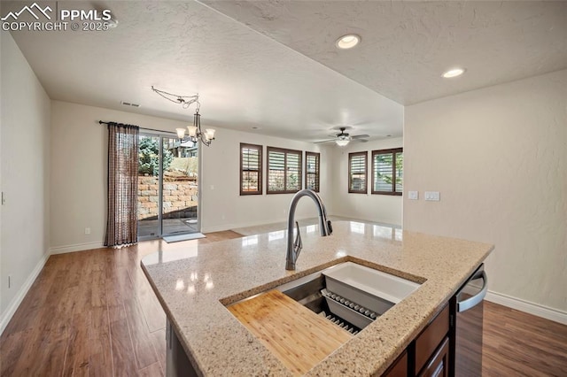 kitchen with dark wood-style flooring, a textured ceiling, and a sink