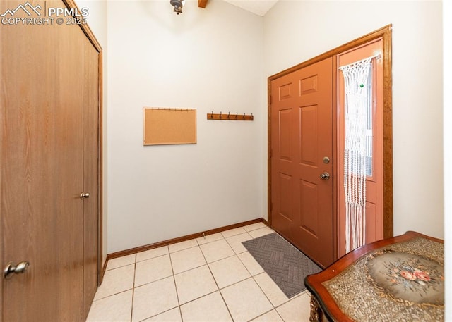 entrance foyer with baseboards and light tile patterned flooring