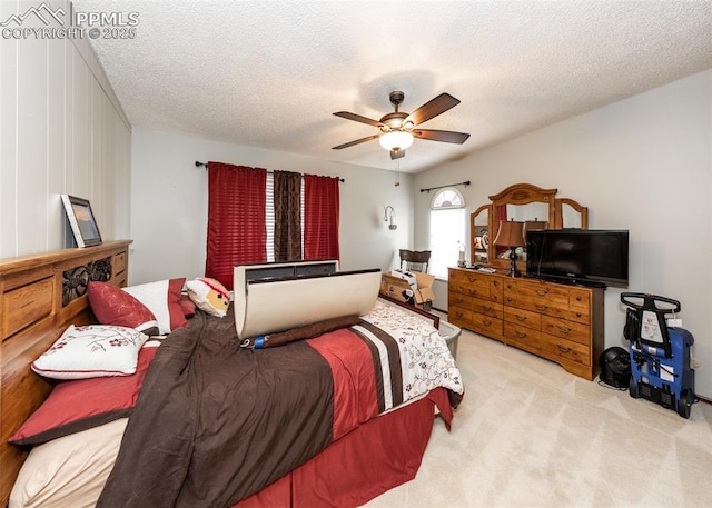 carpeted bedroom featuring a textured ceiling and ceiling fan