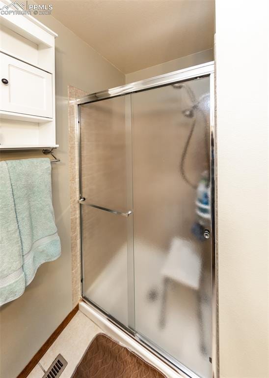 bathroom featuring a shower stall