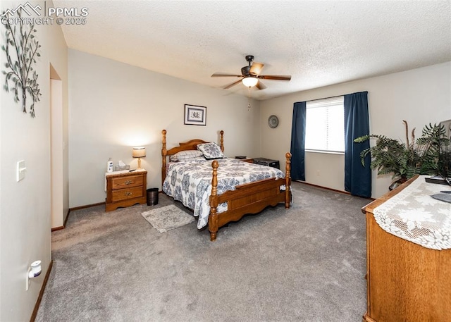 carpeted bedroom featuring baseboards, a textured ceiling, and a ceiling fan