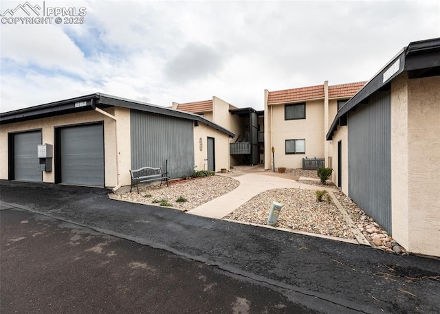 exterior space featuring a garage and stucco siding