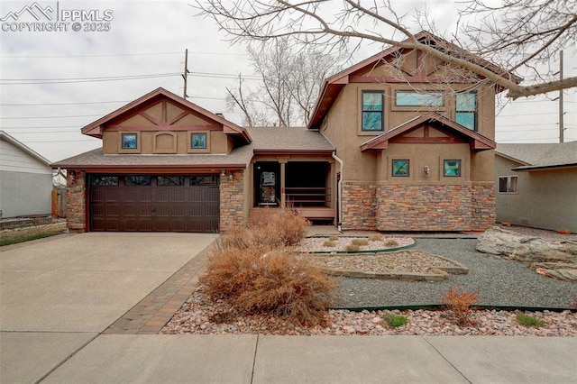 view of front facade with stone siding, driveway, and stucco siding