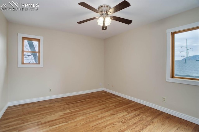 spare room with light wood-style flooring, baseboards, and ceiling fan