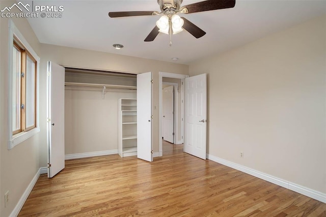 unfurnished bedroom with a closet, baseboards, and light wood-style flooring