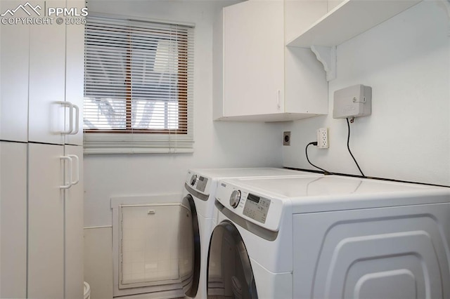 clothes washing area featuring cabinet space and independent washer and dryer