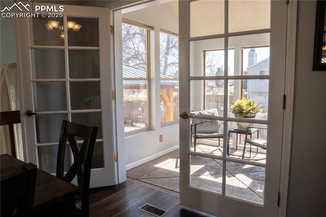 doorway with visible vents, baseboards, dark wood-style flooring, and french doors