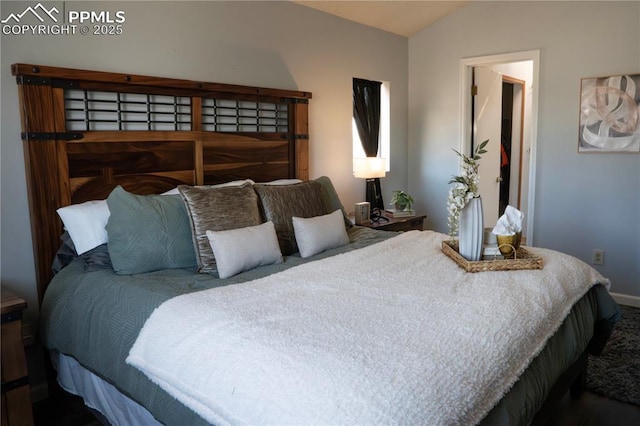 carpeted bedroom with vaulted ceiling