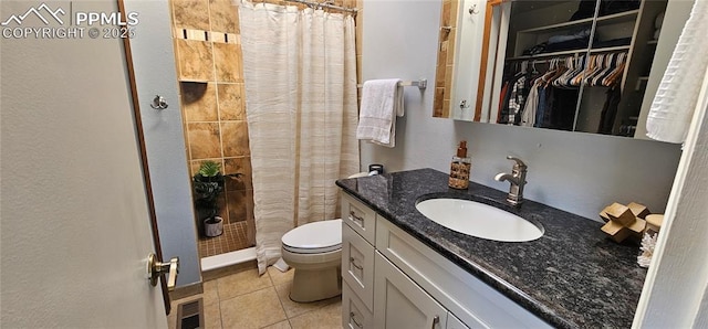 full bathroom featuring visible vents, toilet, tiled shower, tile patterned floors, and vanity