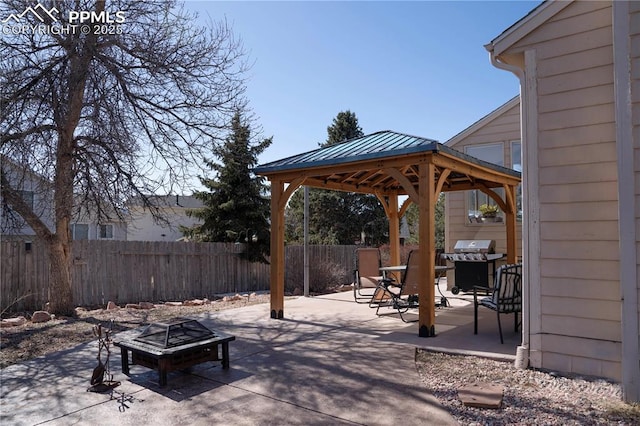 view of patio / terrace with a gazebo, area for grilling, an outdoor fire pit, and fence