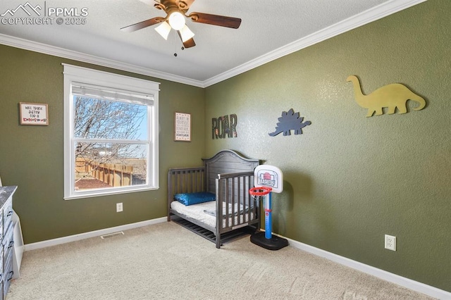 bedroom with carpet flooring, a crib, crown molding, and visible vents