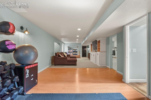 interior space with light wood-style flooring, recessed lighting, and baseboards