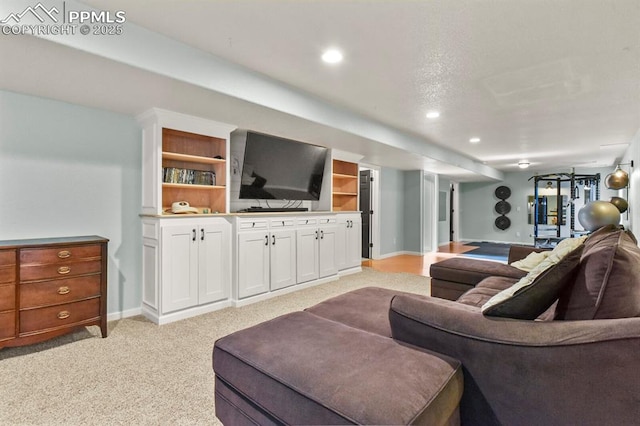 living room with recessed lighting, light colored carpet, and baseboards