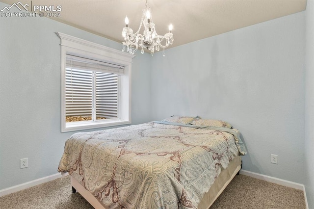 bedroom with baseboards, a chandelier, and carpet flooring