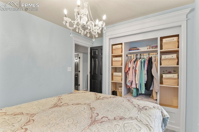 bedroom with an inviting chandelier and a closet