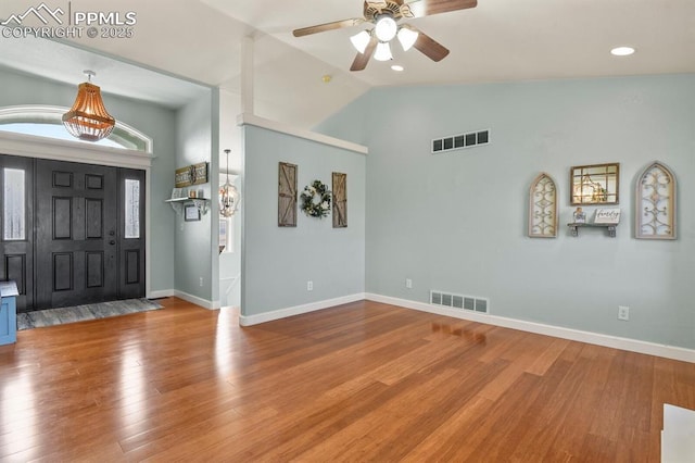 entryway with visible vents, baseboards, lofted ceiling, and wood finished floors