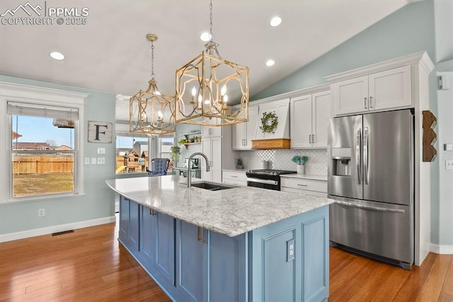 kitchen featuring tasteful backsplash, electric range, stainless steel fridge, white cabinetry, and a sink