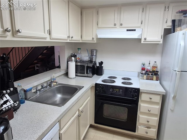 4886 Sonata Dr Unit C, Colorado Springs, CO 80918 - kitchen with freestanding refrigerator, black electric range, custom range hood, stainless steel microwave, and light countertops