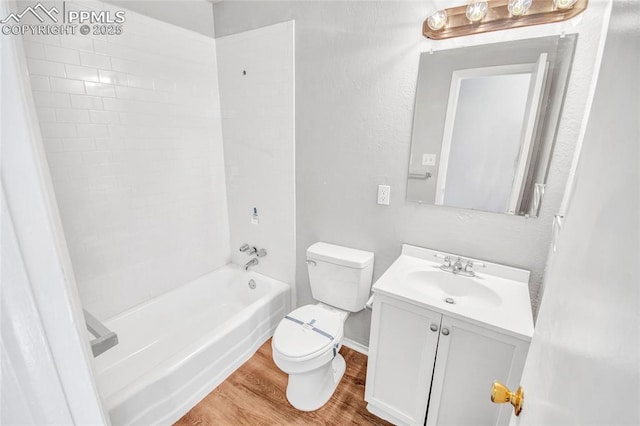 full bath with tub / shower combination, toilet, vanity, and wood finished floors