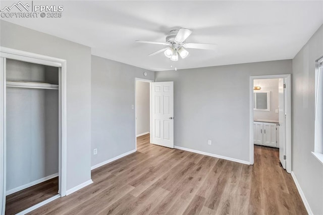 unfurnished bedroom featuring a closet, a ceiling fan, baseboards, and light wood finished floors