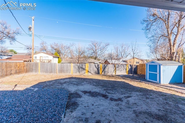 view of yard featuring a fenced backyard, a storage shed, and an outdoor structure