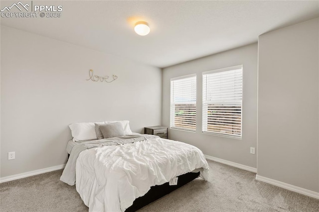 carpeted bedroom featuring baseboards