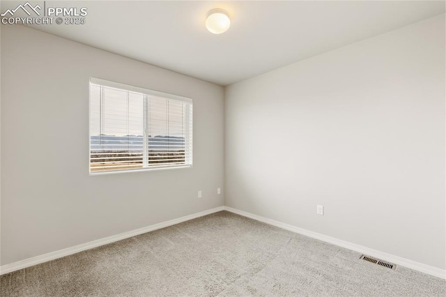 empty room featuring visible vents, carpet flooring, and baseboards