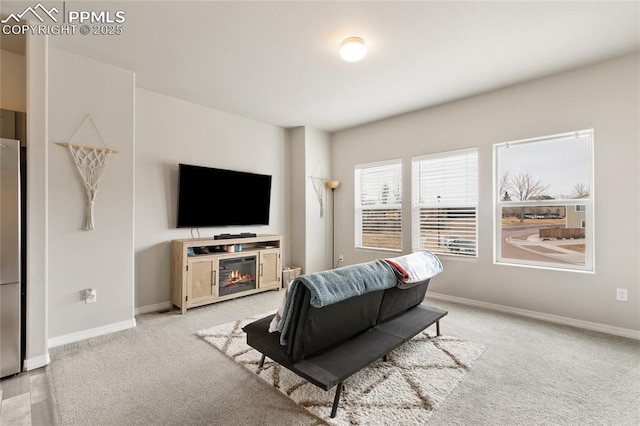 living area with baseboards and carpet flooring