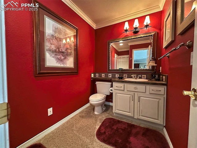 bathroom with baseboards, toilet, vanity, and crown molding