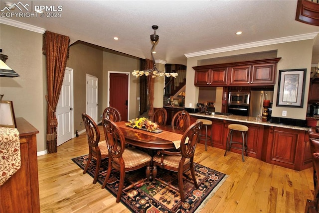 dining room featuring stairway, crown molding, and light wood finished floors