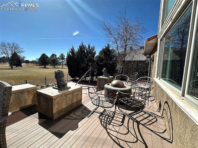 wooden deck featuring a lawn