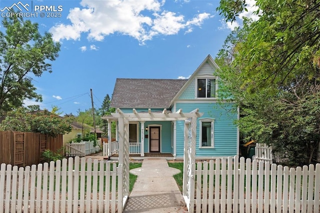 view of front of property featuring a porch, a pergola, and a fenced front yard