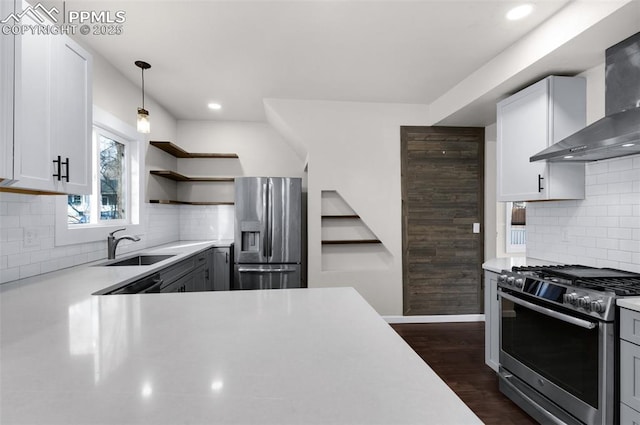 kitchen featuring dark wood-type flooring, open shelves, stainless steel appliances, wall chimney exhaust hood, and light countertops