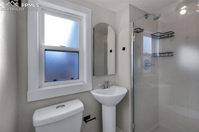 full bathroom with a shower stall and toilet