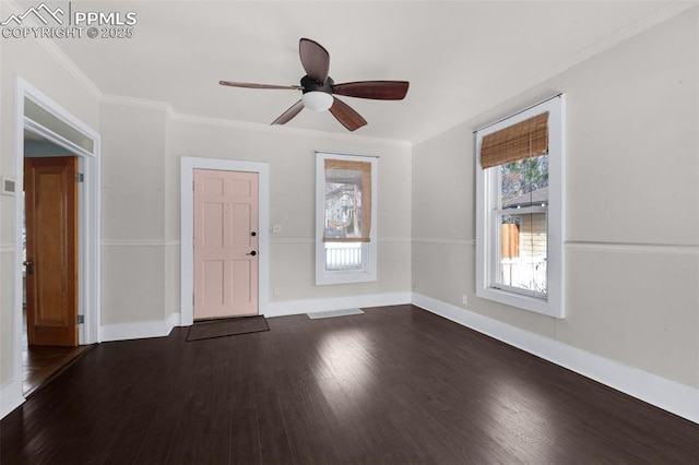 interior space with ceiling fan, crown molding, dark wood-type flooring, and baseboards